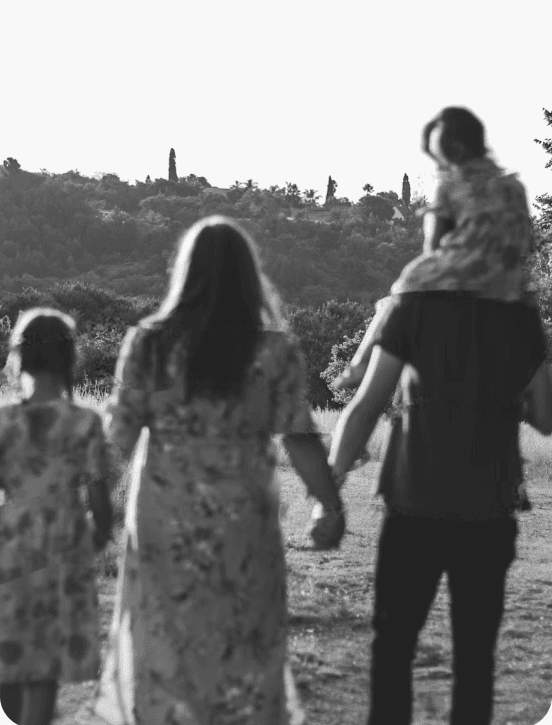 Family walking together away across a natural open horizon